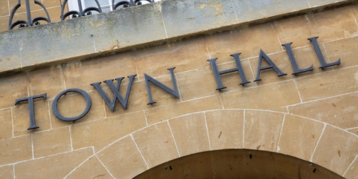 Town hall sign over building entrance