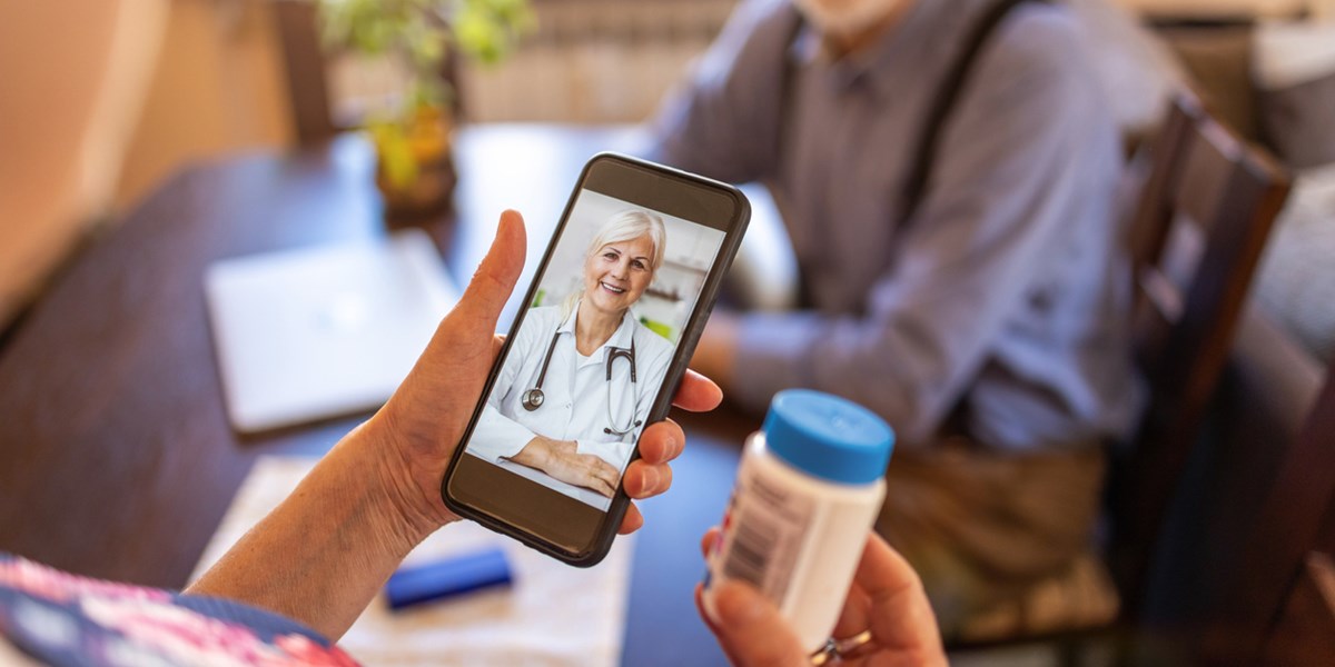 Senior couple consulting with a doctor on mobile phone