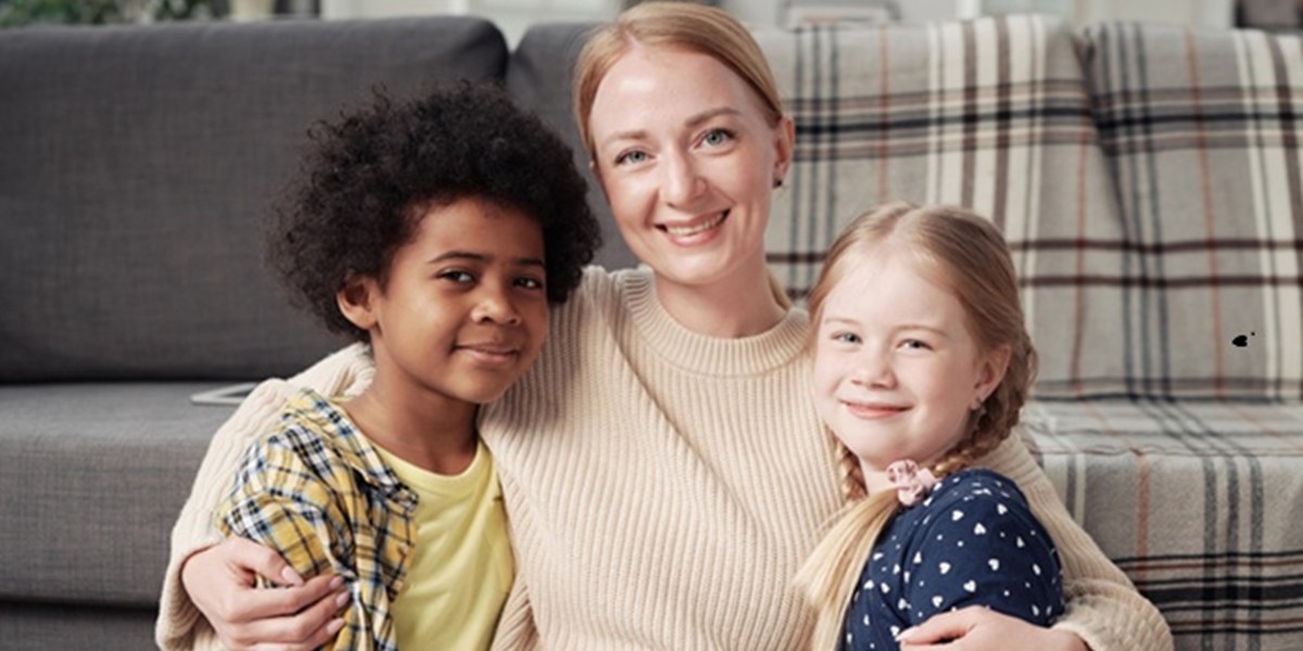 Woman with arms around two children