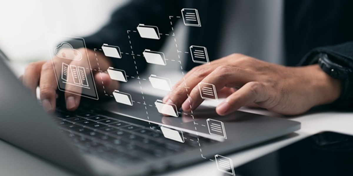 Folder and document icons over typing fingers